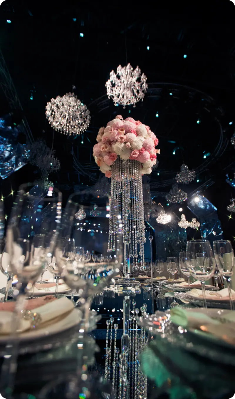 Round floral centerpieces and hanging spherical decorations at night