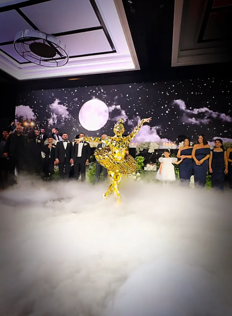 Gold mirror dancer performing on foggy stage before audience