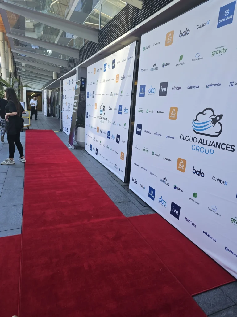 Red carpet carpet runner running alongside printed media backdrop wall