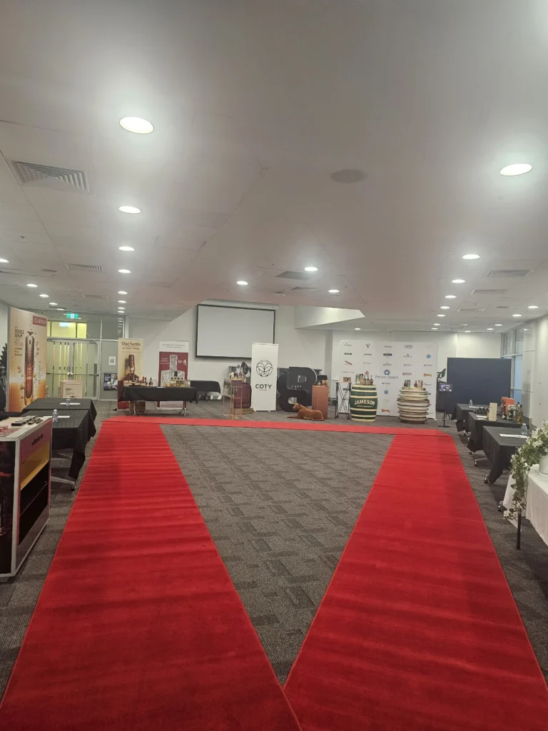 Indoor exhibition space featuring red carpet runner along venue floor