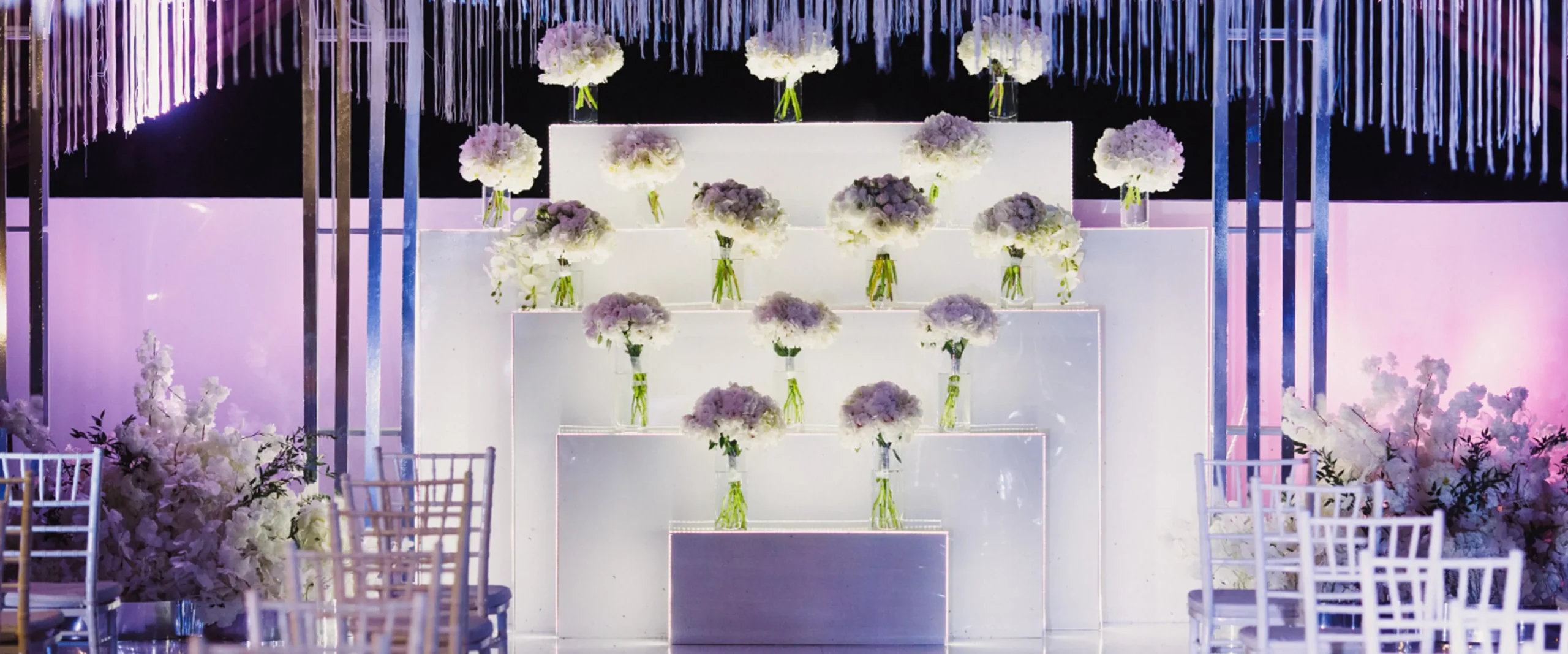 White flower wall backdrop featuring hanging floral decorations