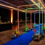 Outdoor path decorated with illuminated square neon light archways