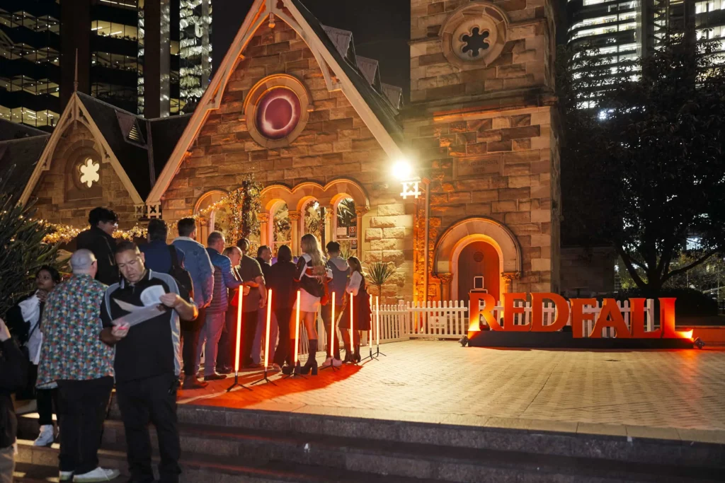 Illuminated outdoor venue entrance near historic building at night event