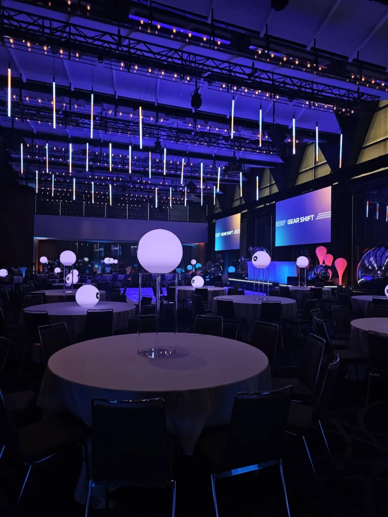 Event hall featuring lit dance floor and vertical tube lights