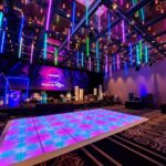 Event hall featuring dance floor and hanging LED tube lights