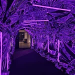 Tunnel walkway illuminated with dramatic purple overhead LED lights