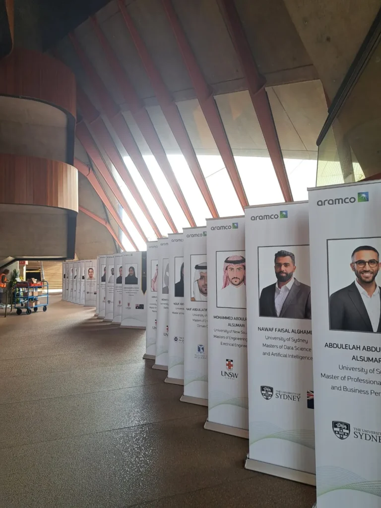 Corporate exhibition display boards set up along indoor venue corridor.
