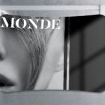 Black and white display wall printed with "MONDE" corporate branding