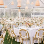 Outdoor event dining area with warm hanging pendant lights