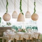 Woven pendant lights hanging above a dining table setup