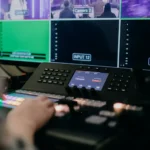 Technician operating a live video switcher board.