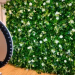 Dense artificial boxwood green hedge backdrop wall setup for events