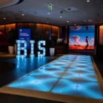 Illuminated LED runway leading toward BIS marquee letters stage
