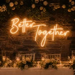 Warm white "Better Together" neon sign mounted on brick backdrop