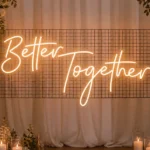 Warm white "Better Together" neon sign mounted on grid screen