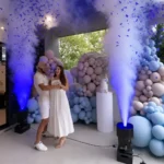 Fog machine blasts producing white smoke jets at event