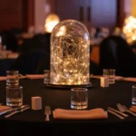 Clear glass cloche dome filled with warm glowing fairy lights
