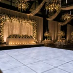 White LED dance floor setup in elegantly decorated reception room