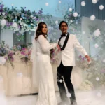 Bride and groom celebrating under floating smoke-filled bubbles