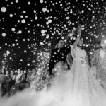 Black-and-white shot of a couple surrounded by floating smoke bubbles