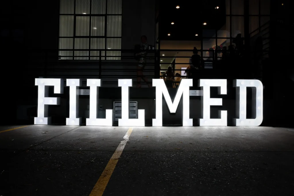 Illuminated white marquee letters spelling