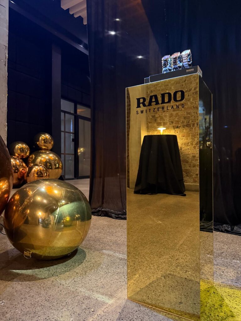 RADO promotional display with gold balloons