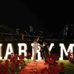 Couple with cold sparklers and MARRY ME letters in Sydney.