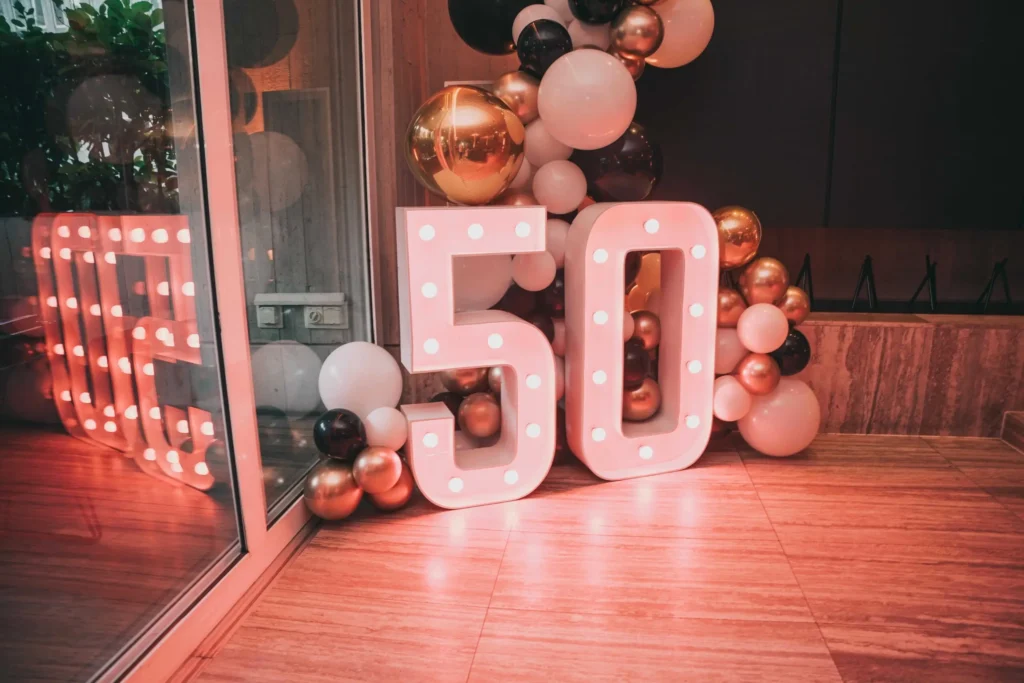 50th birthday balloon decor with giant light-up number 50
