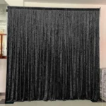 Black fringe tassel backdrop curtain hanging on venue frame structure