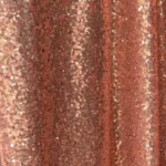 Rose gold sequin backdrop fabric with shimmering metallic texture.