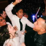 Energetic wedding guests dancing