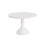 White pedestal cake stand against a plain white background