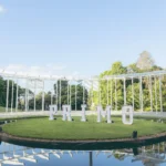 Outdoor venue displaying white marquee letters on green grass