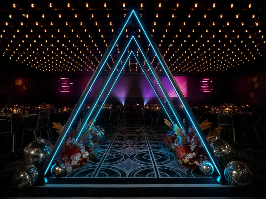 Futuristic glowing triangular archway tunnel at event setup