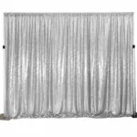 Silver metallic tinsel fringe curtain backdrop display.