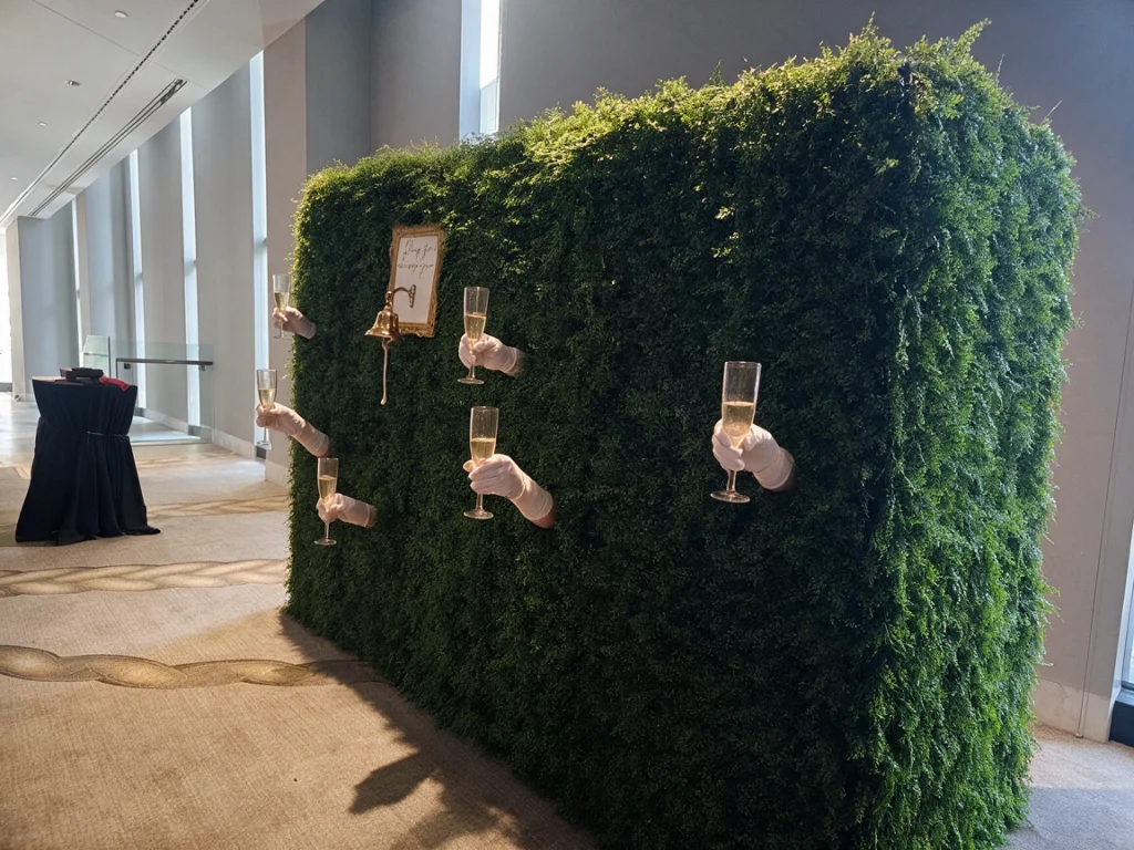 Tall green hedge wall panels with hanging lantern decorations