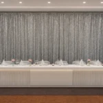 Gray sheer backdrop curtain panel installation in venue room.