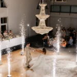 Grand hall setup featuring elaborate central crystal chandelier decoration