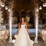 Bride walking through cold spark entrance