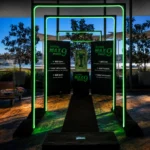 Green neon rectangular entry archway framed by glass windows