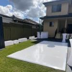 Outdoor white glossy dance floor set up in backyard